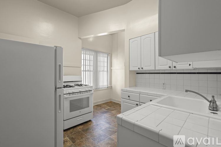 A modern kitchen with white appliances and cabinets.
