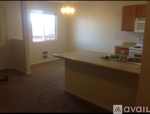 A kitchen area with a sink and a window.