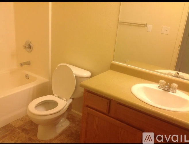 A bathroom with a toilet, sink, and bathtub.
