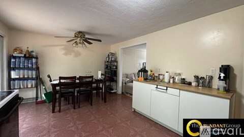 A kitchen with a table and chairs in the middle of the room.