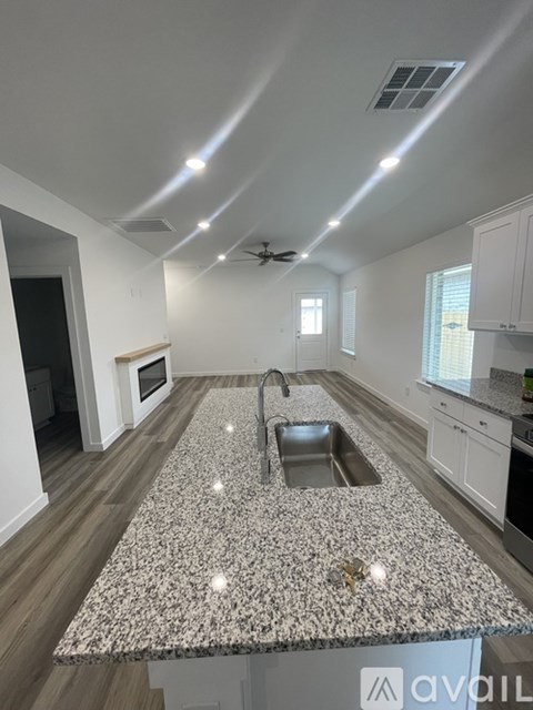 A kitchen with a granite countertop and a sink.