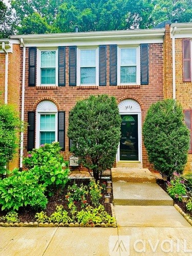 A brick house with a green door and windows.