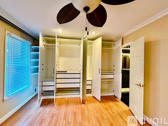 A room with a ceiling fan and bunk beds.