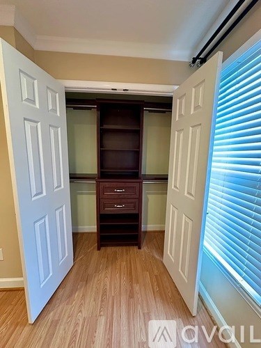 A room with a white door and a brown cabinet.