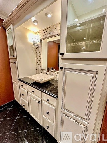 A bathroom with a sink and mirror.