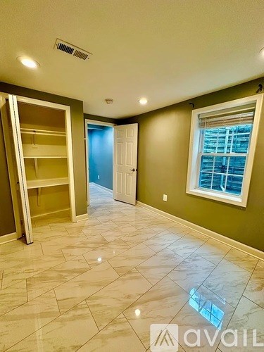A room with a large closet and a window.