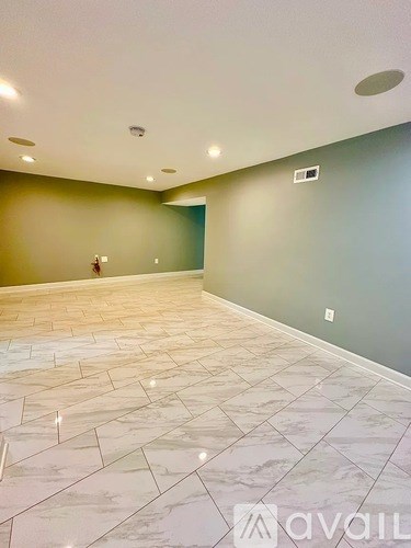 A room with a marble floor and a green wall.