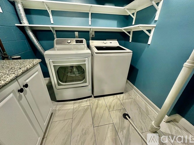 A small kitchen with a washer and dryer.
