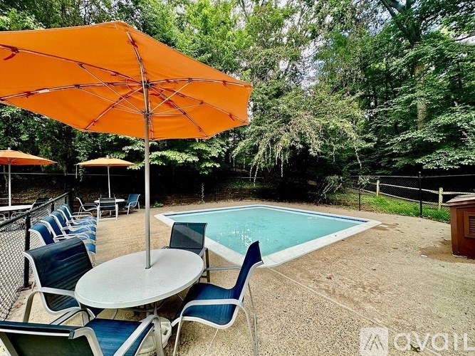 A pool area with chairs and umbrellas is available.
