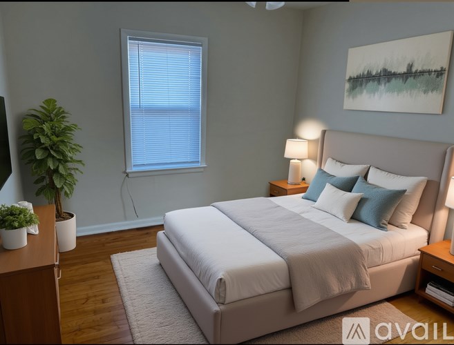 A bedroom with a large bed and a painting on the wall.