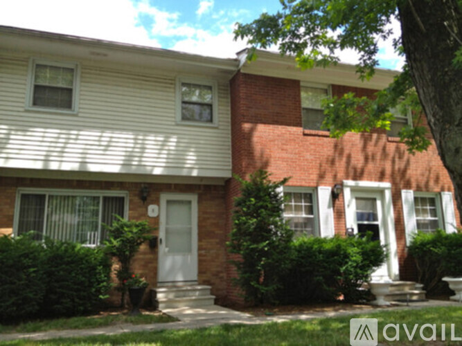 A house with a white door and a brick chimney.