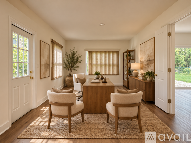 A living room with a brown rug and two chairs.