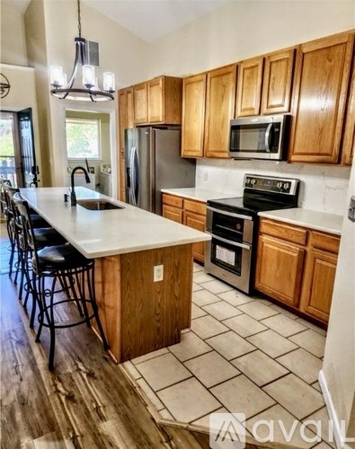 A kitchen with wooden cabinets and a white countertop.