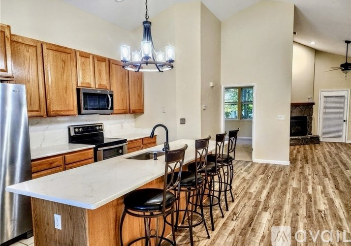 A kitchen with wooden cabinets and a white countertop.