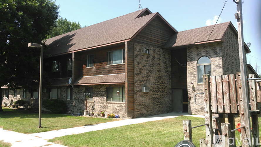 A house with a brown roof and stone walls.