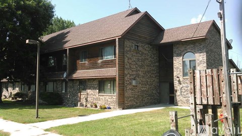 A house with a brown roof and stone walls.