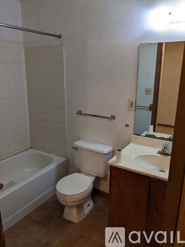 A bathroom with a toilet, sink, and bathtub.