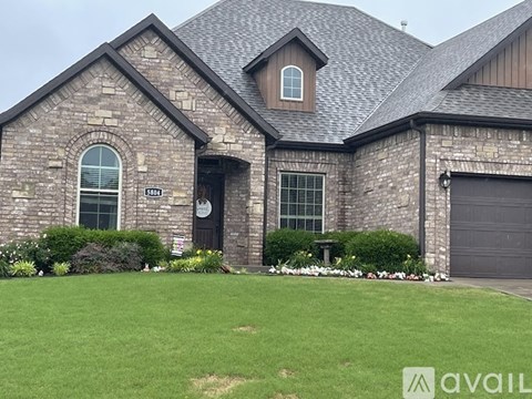 A house with a stone facade and a garage door.