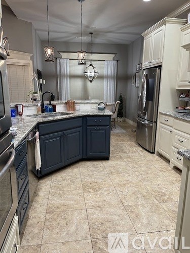 A kitchen with a blue counter and a white fridge.