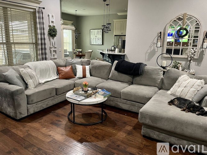 A living room with a grey couch and a coffee table.