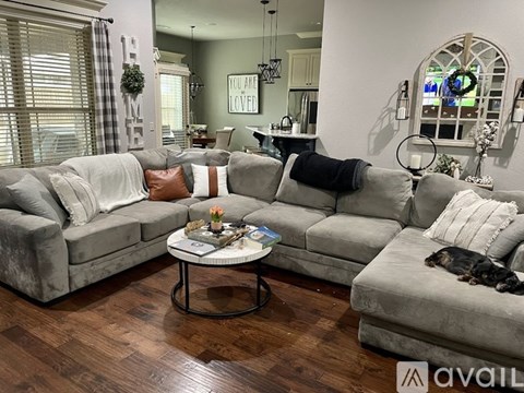 A living room with a grey couch and a coffee table.