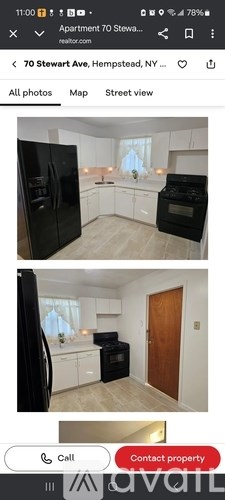 A black refrigerator and oven in a kitchen with white cabinets.