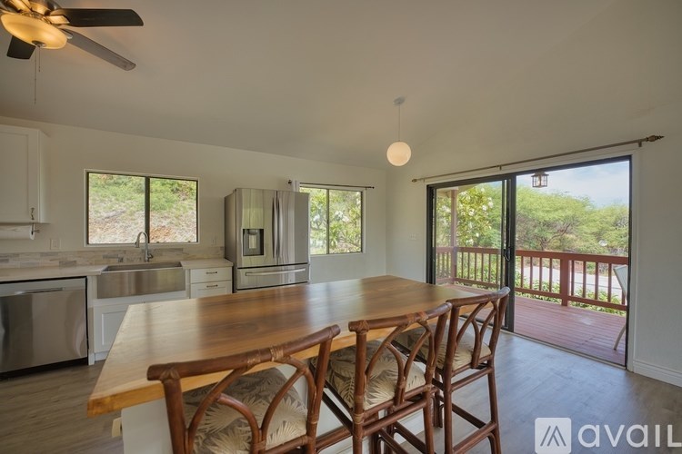 A kitchen with a dining table and chairs is available for rent.