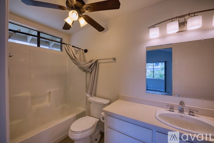 A white bathroom with a toilet, sink, and bathtub.