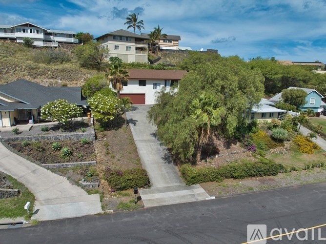 A residential area with houses and a clear sky.