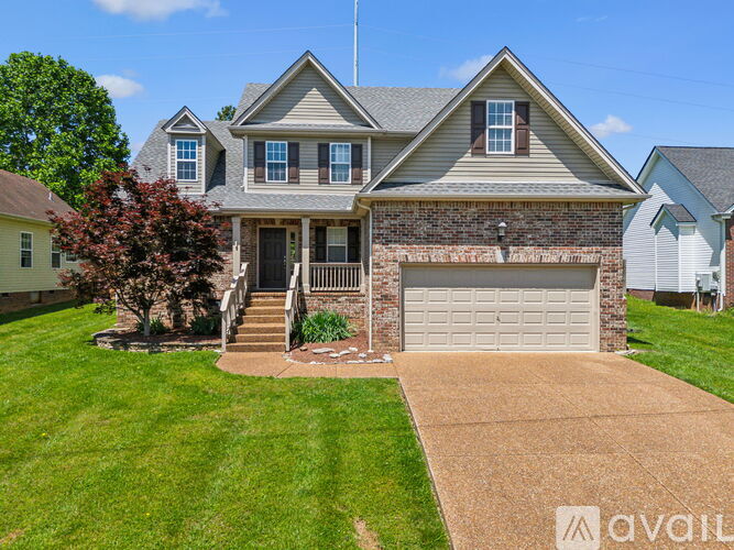 A house with a garage and a driveway is for sale.