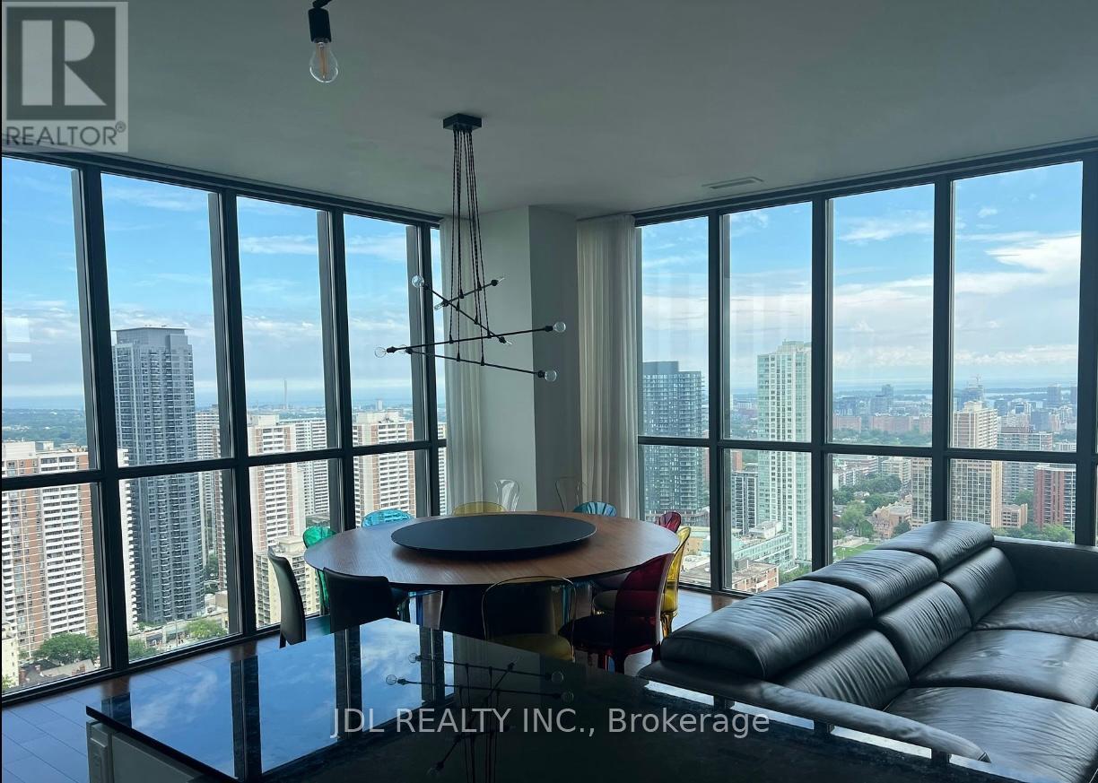A living room with a view of the cityscape through large windows.
