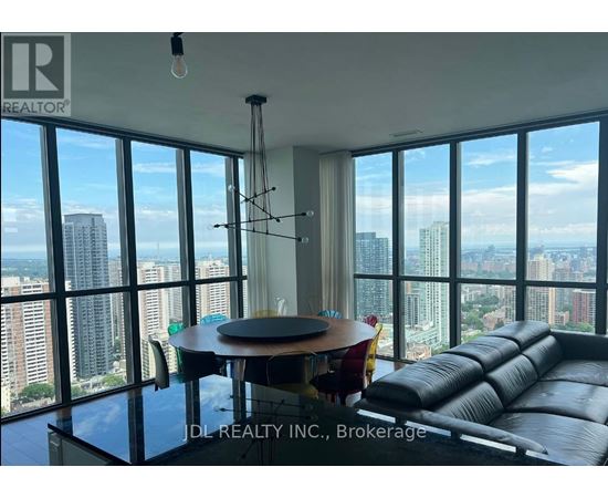 A living room with a view of the cityscape through large windows.