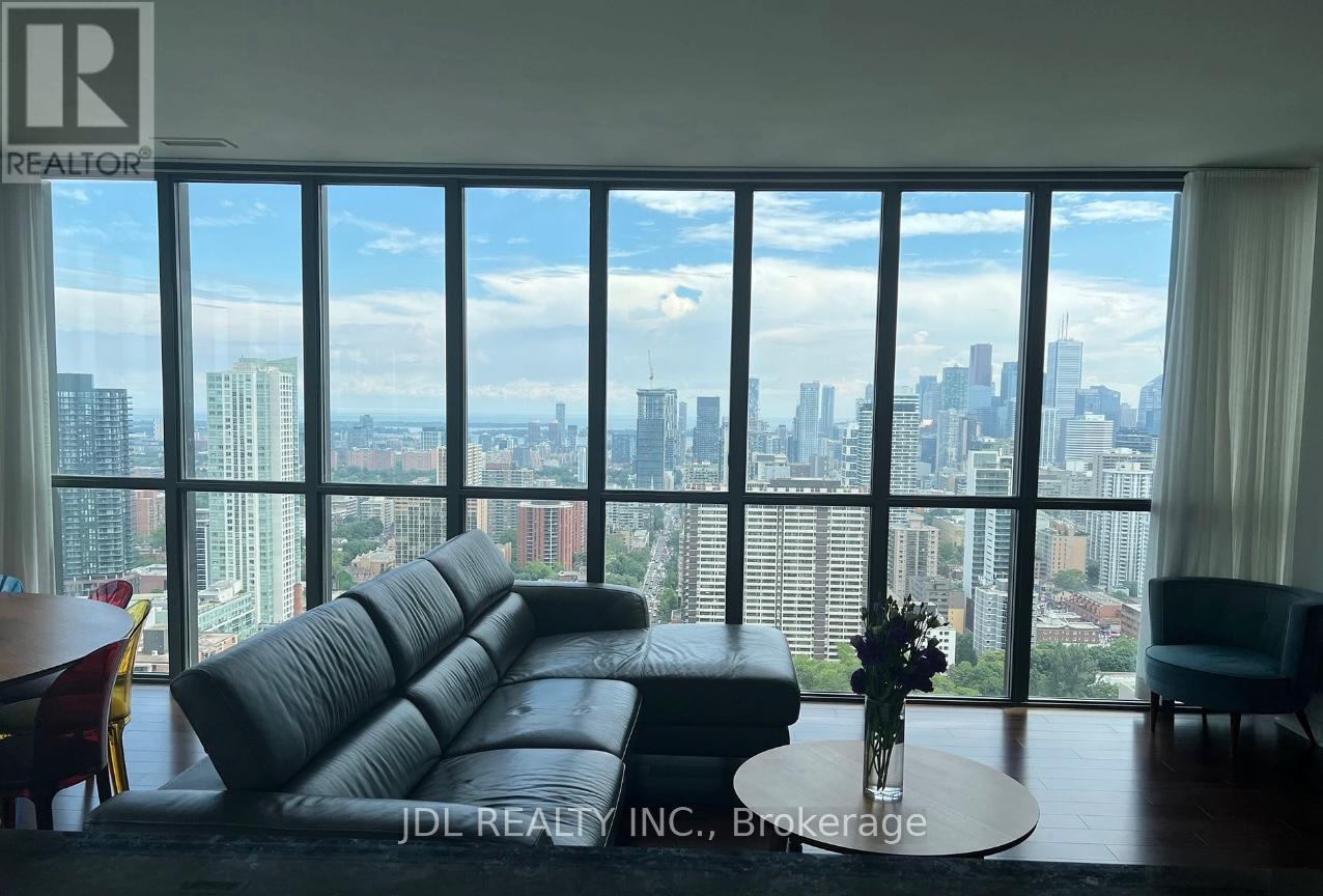 A living room with a large window overlooking a city skyline.