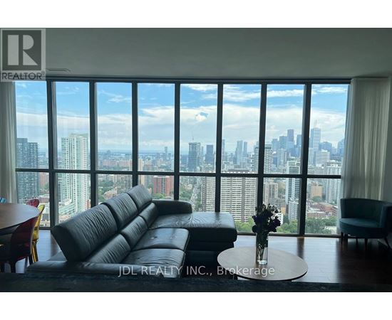 A living room with a large window overlooking a city skyline.
