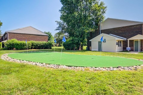 a putting green in the front yard of a house