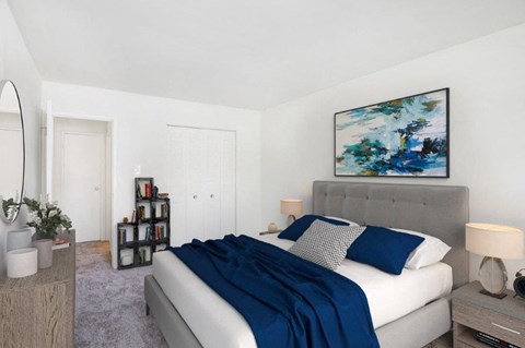 a bedroom with a white bed and a blue blanket