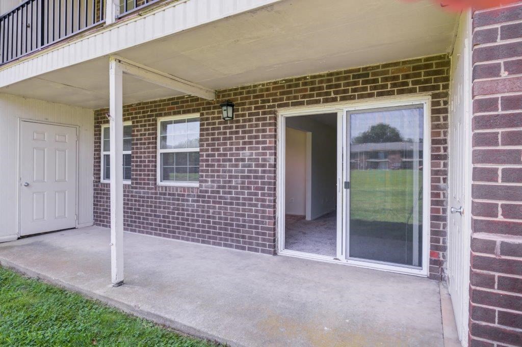 the entrance to a brick building with a glass door