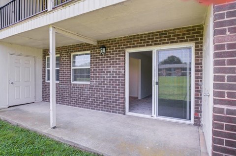 the entrance to a brick building with a glass door