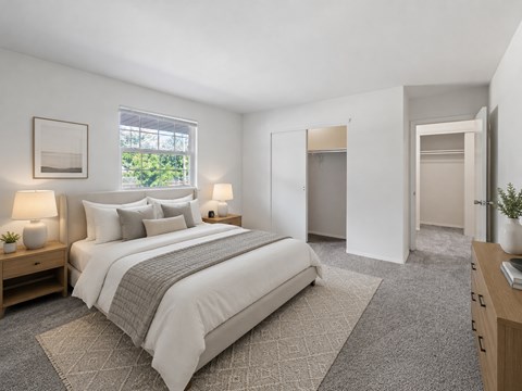 A bedroom with a large bed and a window.