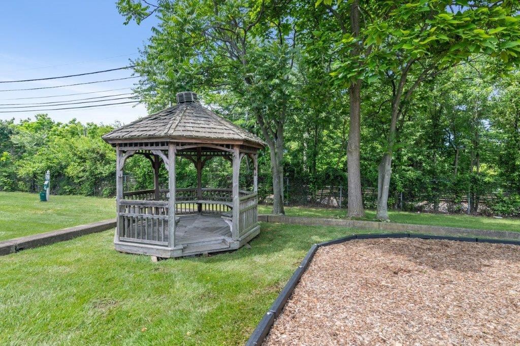 a gazebo in the middle of a grass field