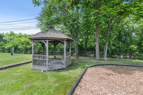 a gazebo in the middle of a grass field