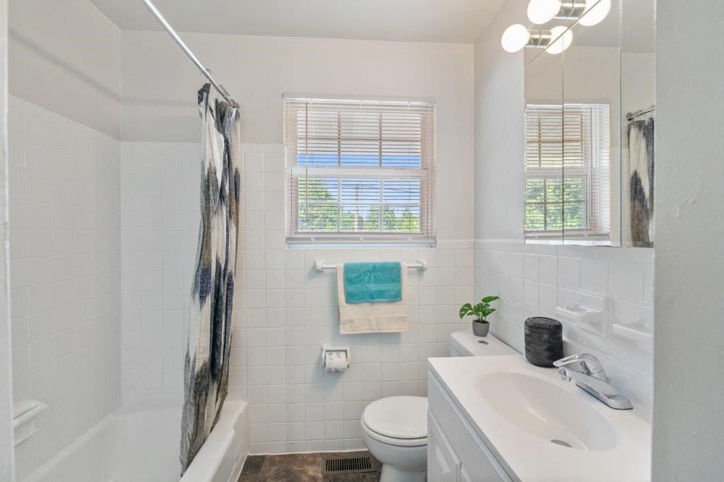 a bathroom with a sink toilet and a bath tub