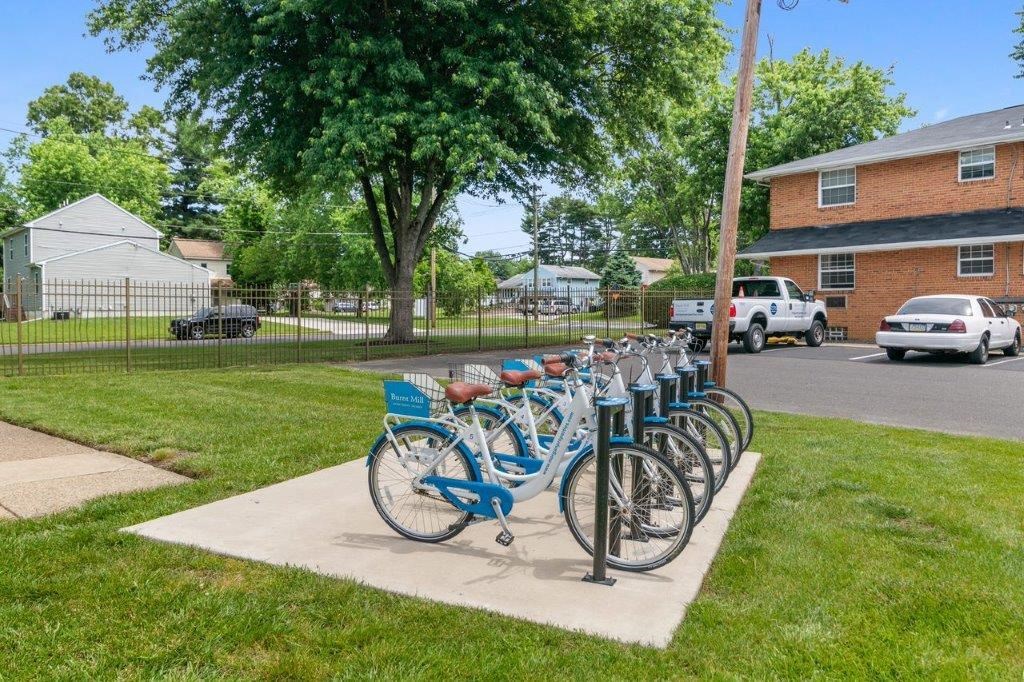 a row of bikes parked next to a pole