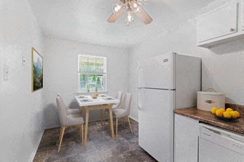a kitchen with a table and chairs and a refrigerator