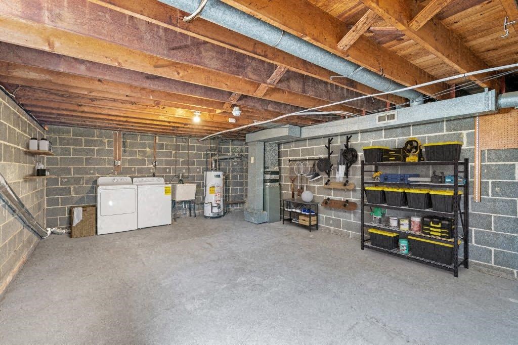 the inside of a garage with a fridge and a shelf