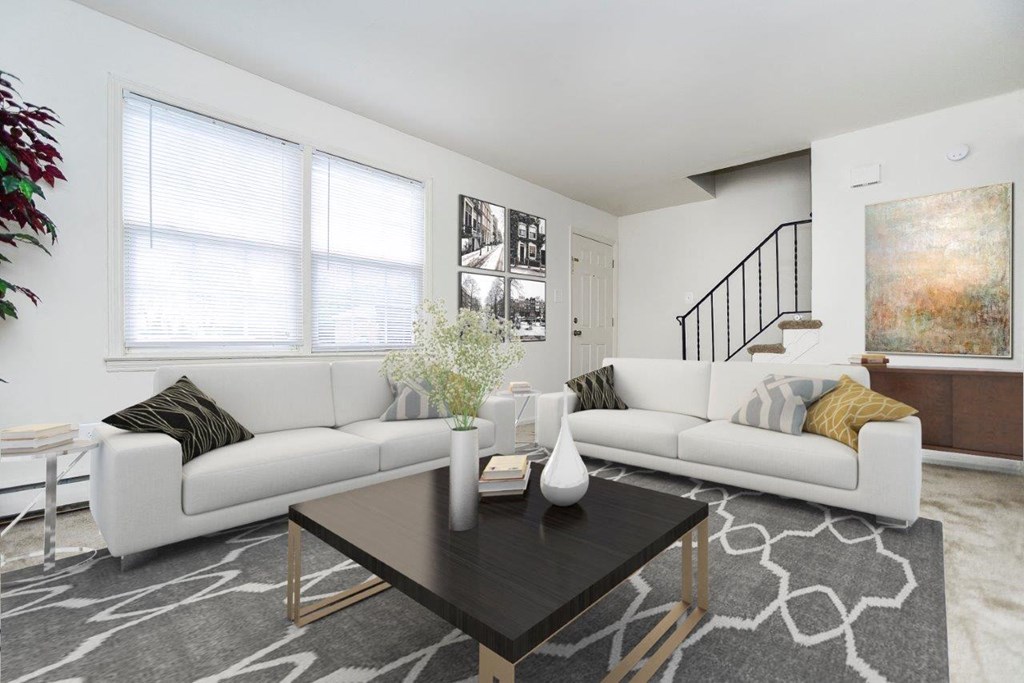 a living room with two white couches and a coffee table