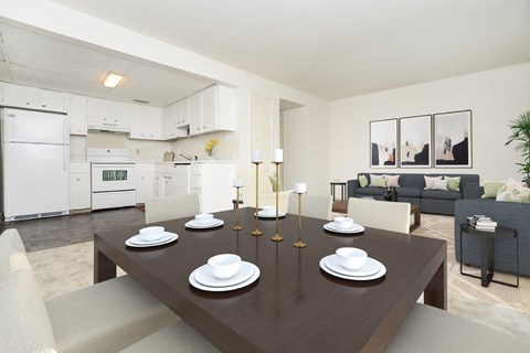 a dining room and living room with a table and chairs
