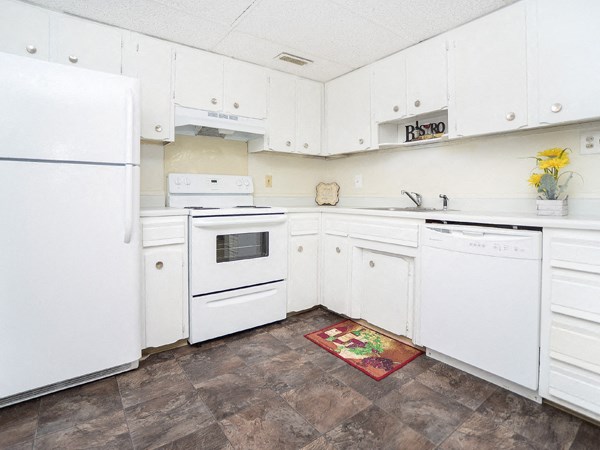 a white kitchen with white appliances and white cabinets