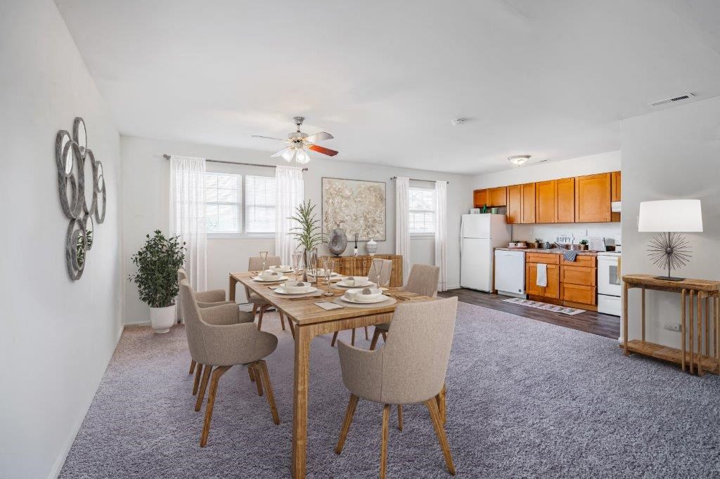 a dining room with a table and chairs and a kitchen
