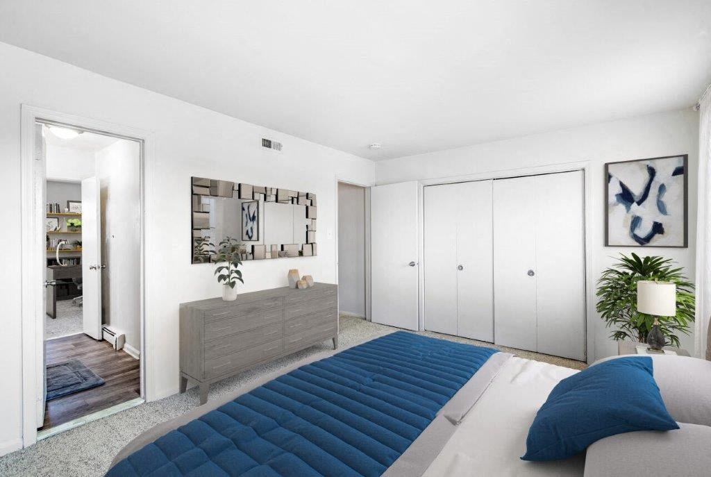 a bedroom with a blue bed and a mirror